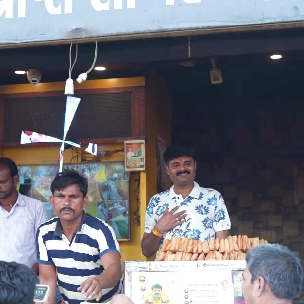 Customer at the original Silao Khaja shop in Nalanda, Bihar, with a Shrikalisah-brand pack