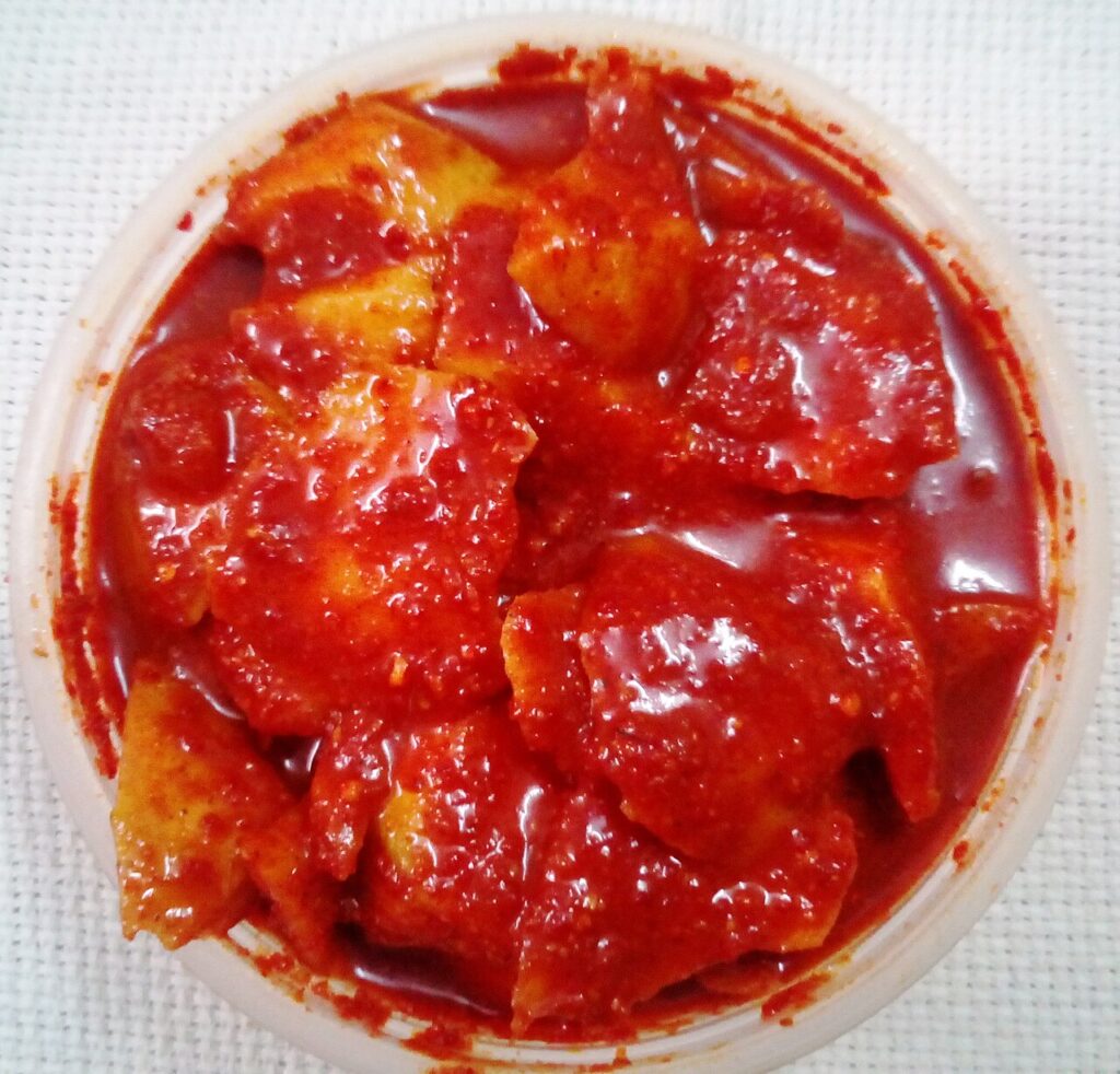 Chopped raw mango pieces coated in pickle masala