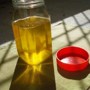 Pure desi cow ghee golden liquid in a glass bottle