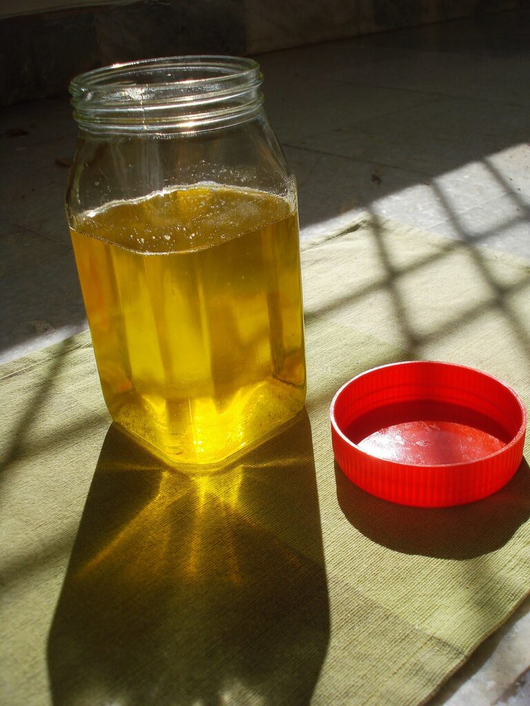 Pure desi cow ghee golden liquid in a glass bottle