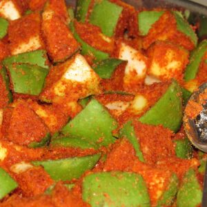 Traditional Indian mango pickle close-up in a bowl