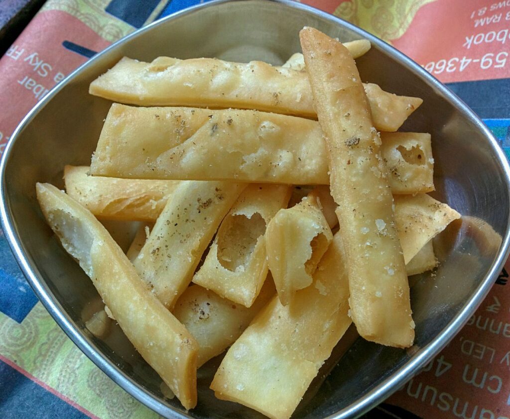 Bihari nimki namak para diamonds piled in a bowl, crisp and golden