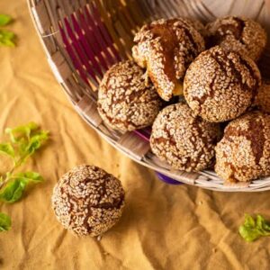 Anarsa from the Magadh region of Bihar — sesame-coated fried sweets in a wicker basket