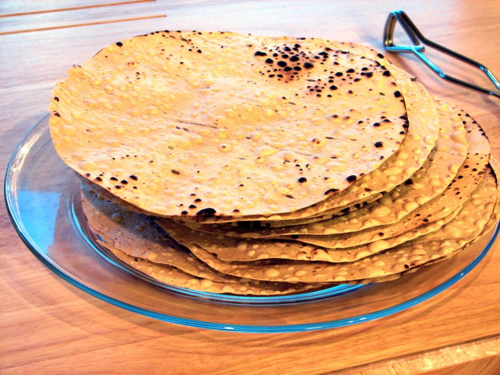 Bihari Urad Papad — stack of thin sun-dried urad dal wafers ready to roast