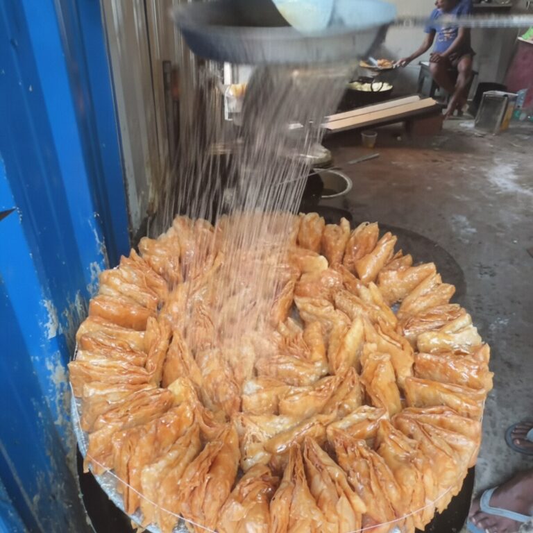 Meetha Khaja — sugar syrup being poured on a fresh-fried Silao Khaja wheel at the original halwai workshop (the defining 'meetha' moment)