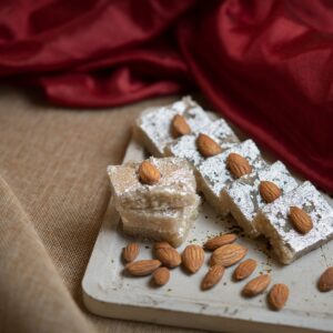 Khurma — Bihari khoa-based milk sweet, soft cream squares with a light nut garnish