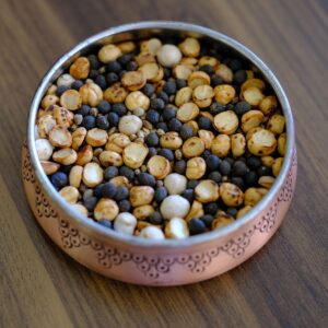 Roasted Bengal gram (bhuna chana) in a copper bowl — the toasted gram blended into Bihari chana chivda