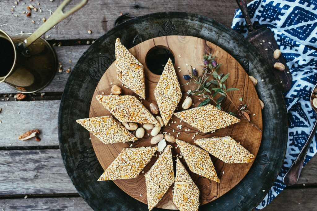 Sriram Gaya Tilkut — sesame and jaggery pieces arranged on dark wood, Gaya, Bihar