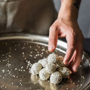 Sriram Tilkut — roasted sesame-and-jaggery sweet rounds piled on a serving tray