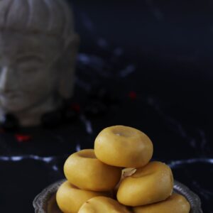 Kesaria Peda — saffron khoya peda discs on a brass plate